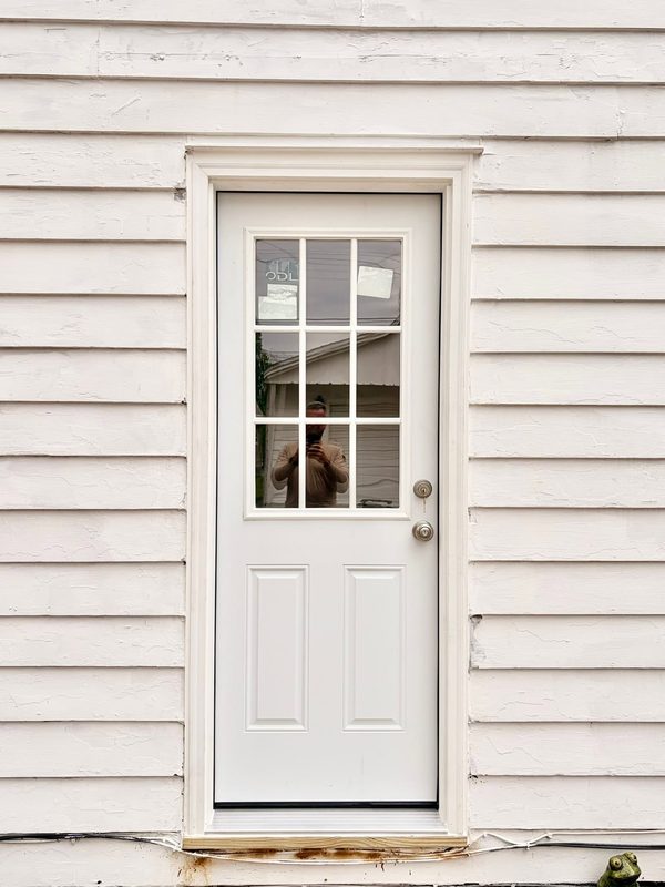New nine-lite back door with fresh casing and threshold