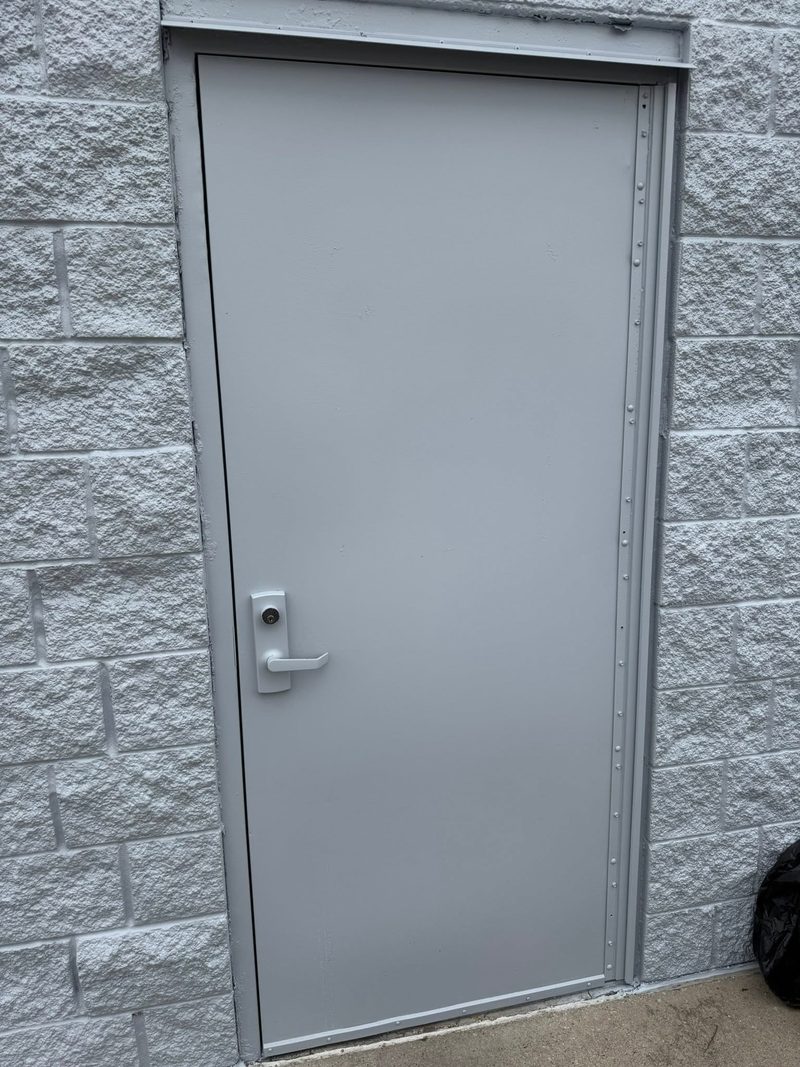 Hollow-metal commercial door set in a painted block wall