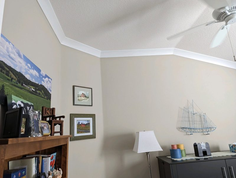 White crown molding following an angled ceiling line
