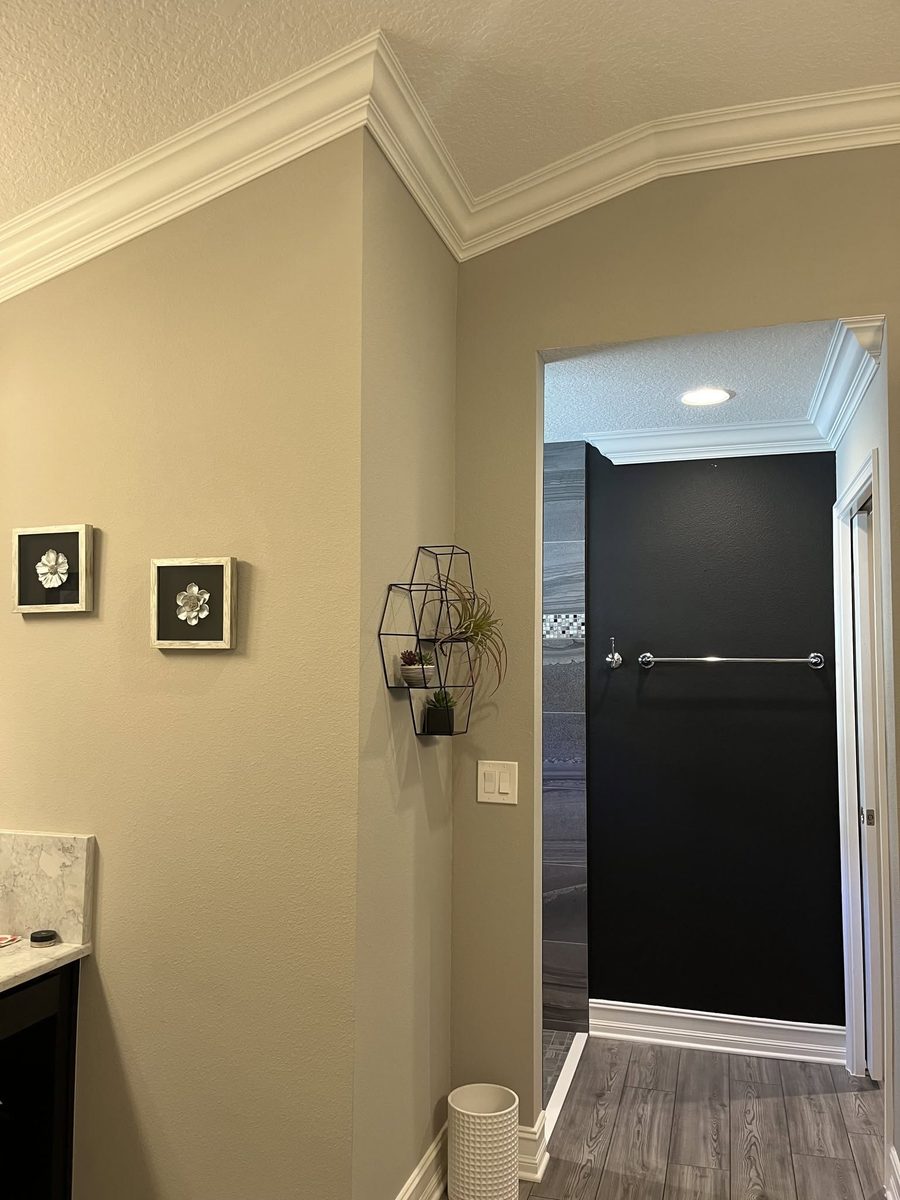 Built-up crown molding and tall baseboard in a bathroom