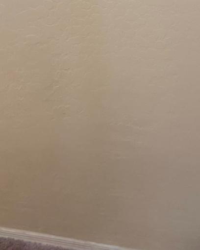 The same wall patched, retextured and repainted with no visible seam