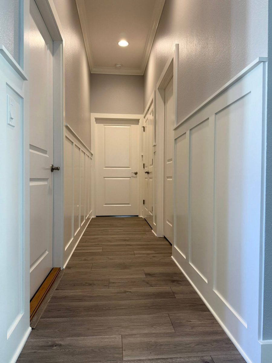 Board-and-batten wainscoting and painted door casing in a hallway