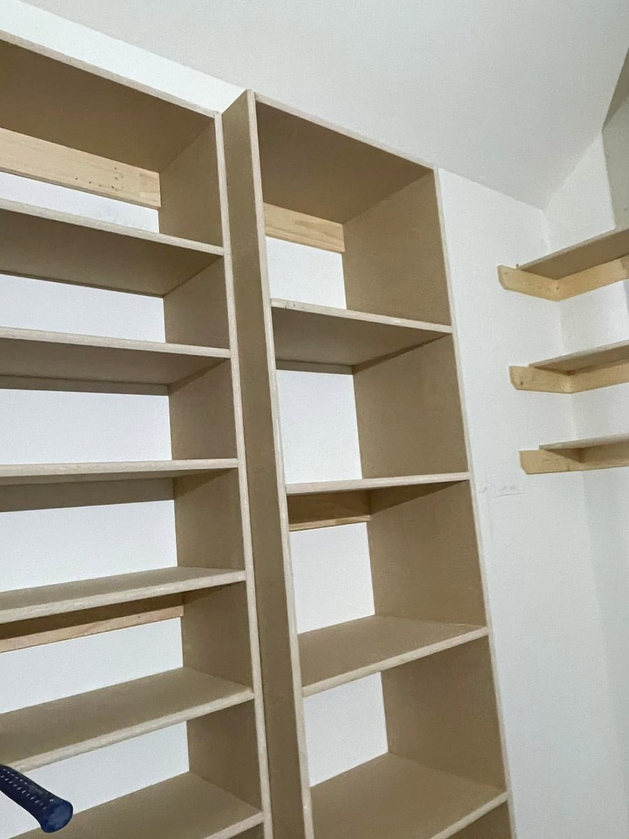 Unfinished MDF built-in closet shelving with floating shelf cleats