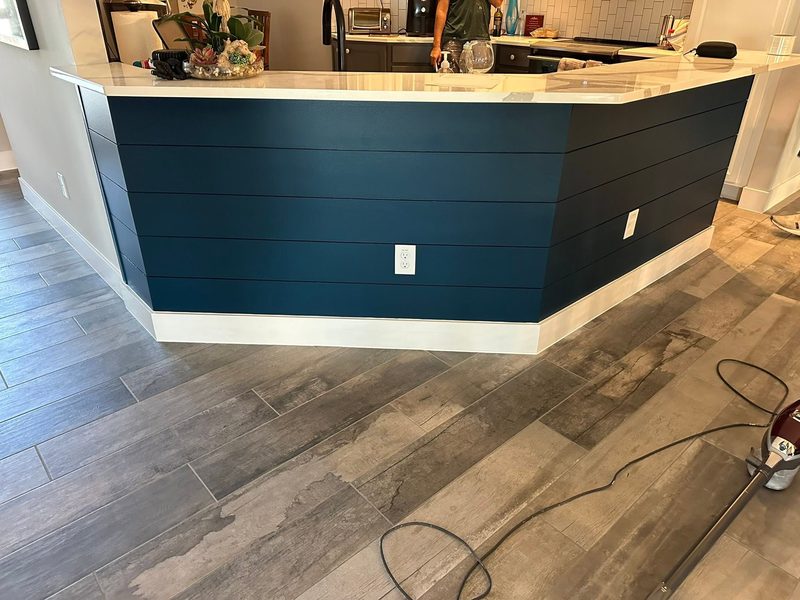 Navy shiplap paneling wrapped around a kitchen peninsula