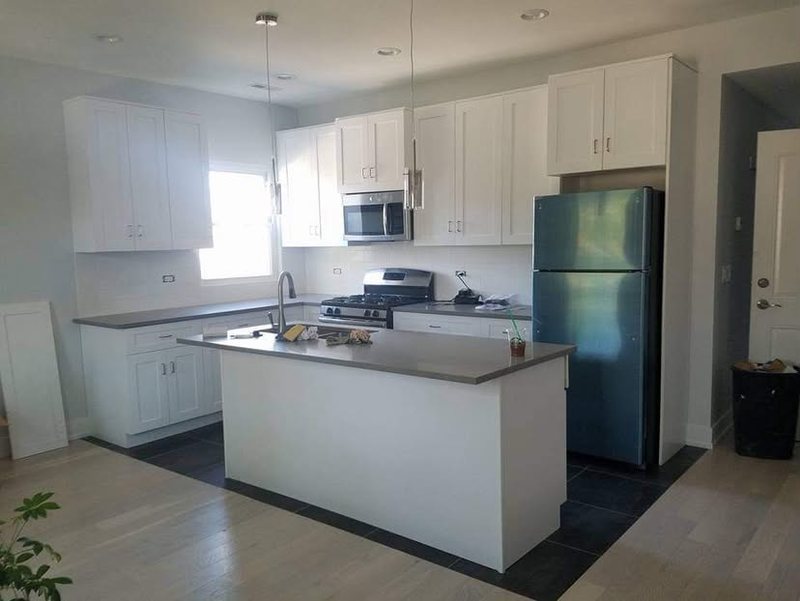 White shaker kitchen with an island and grey countertops